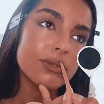 A Close Up Of A Woman 'S Face With A Pencil In Her Mouth GIF