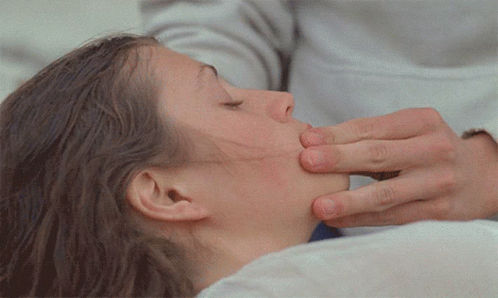 A Close Up Of A Woman 'S Face With A Person 'S Hand On It GIF