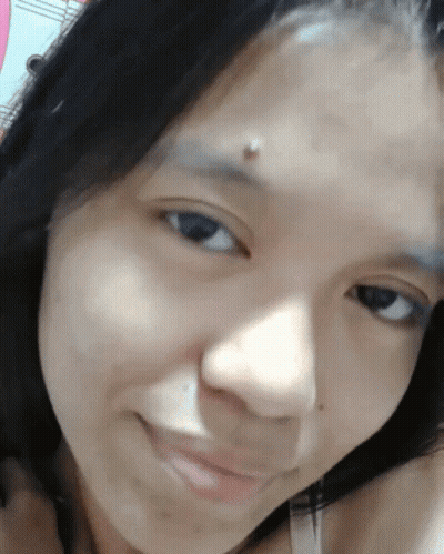 A Close Up Of A Woman 'S Face With A Piercing On Her Forehead GIF