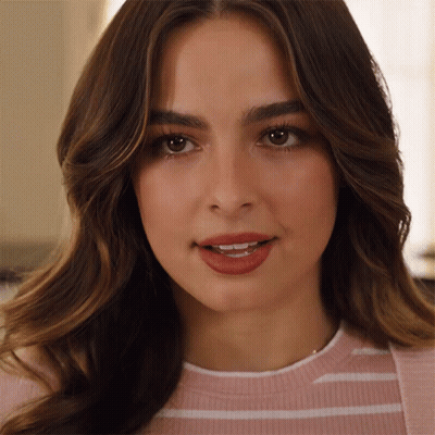 A Close Up Of A Woman 'S Face With A Pink And White Striped Shirt On GIF
