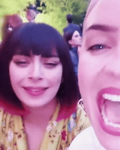 A Close Up Of A Woman 'S Face With A Pink Background GIF