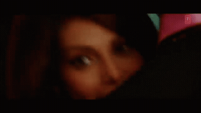 A Close Up Of A Woman 'S Face With A Pink Shirt On . GIF