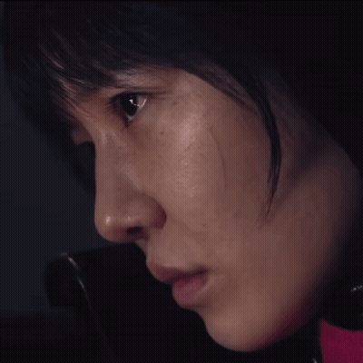 A Close Up Of A Woman 'S Face With A Pink Shirt On GIF