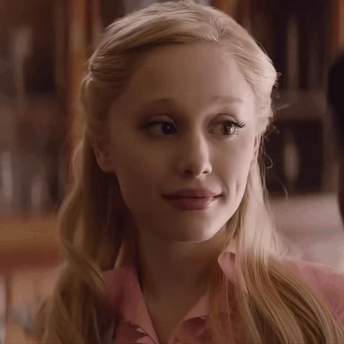 A Close Up Of A Woman 'S Face With A Pink Shirt On GIF