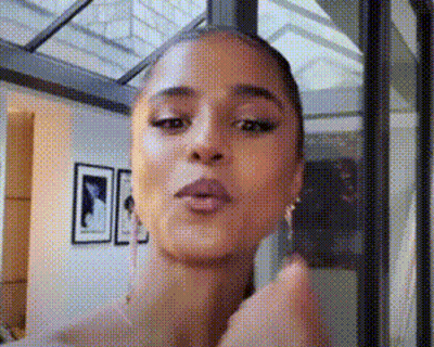 A Close Up Of A Woman 'S Face With A Polka Dot Pattern . GIF