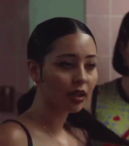 A Close Up Of A Woman 'S Face With A Ponytail . GIF