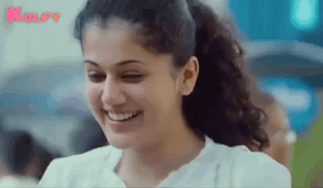A Close Up Of A Woman 'S Face With A Ponytail And Smiling . GIF