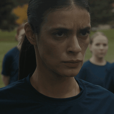 A Close Up Of A Woman 'S Face With A Ponytail GIF