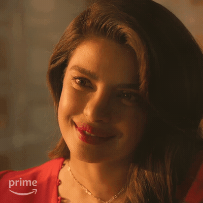 A Close Up Of A Woman 'S Face With A Prime Logo Behind Her GIF