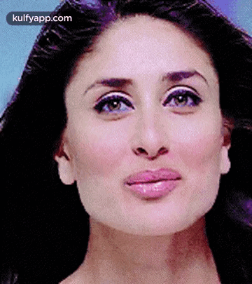 A Close Up Of A Woman 'S Face With A Purple Background And A Pink Lip . GIF