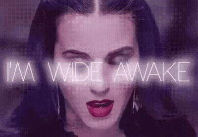 A Close Up Of A Woman 'S Face With A Purple Background And The Words `` I 'M Wide Awake '' Behind Her GIF