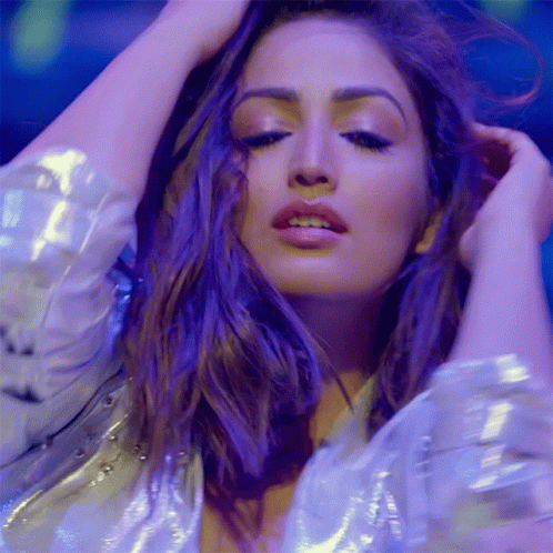 A Close Up Of A Woman 'S Face With A Purple Background GIF