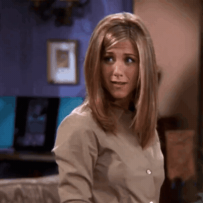 A Close Up Of A Woman 'S Face With A Purple Wall In The Background GIF