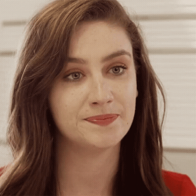 A Close Up Of A Woman 'S Face With A Red Jacket On GIF