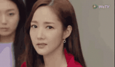 A Close Up Of A Woman 'S Face With A Red Jacket On . GIF