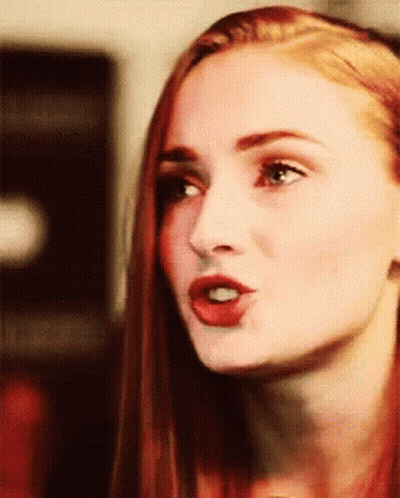 A Close Up Of A Woman 'S Face With A Red Lip GIF
