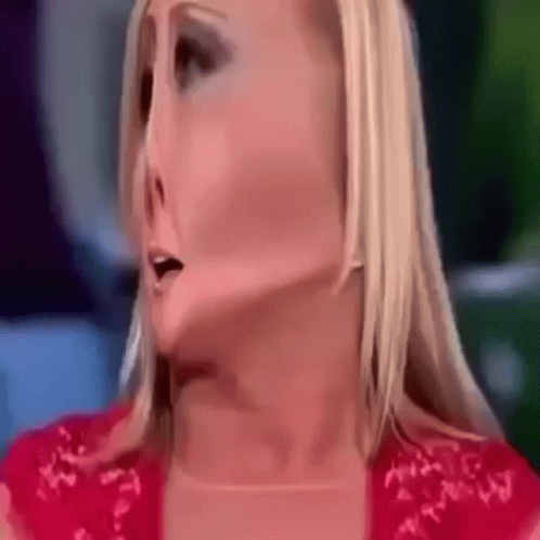 A Close Up Of A Woman 'S Face With A Red Shirt On GIF