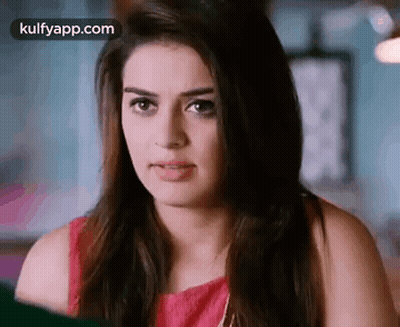 A Close Up Of A Woman 'S Face With A Red Top On . GIF
