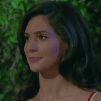 A Close Up Of A Woman 'S Face With A Red Top On GIF