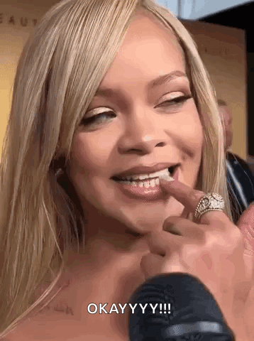 A Close Up Of A Woman 'S Face With A Ring On Her Finger And The Words `` Okay Yy ! '' GIF