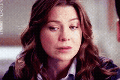 A Close Up Of A Woman 'S Face With A Sad Look On Her Face GIF