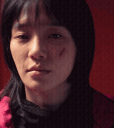 A Close Up Of A Woman 'S Face With A Scar On Her Face GIF