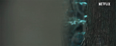 A Close Up Of A Woman 'S Face With A Scarf Around Her Neck And A Netflix Logo In The Corner . GIF