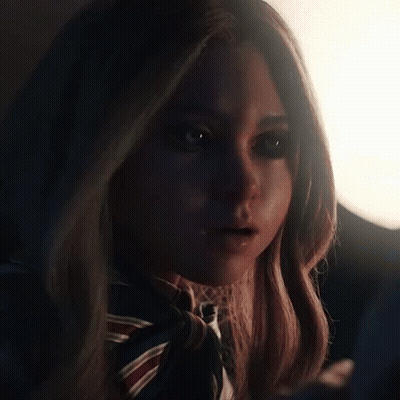 A Close Up Of A Woman 'S Face With A Scarf Around Her Neck . GIF
