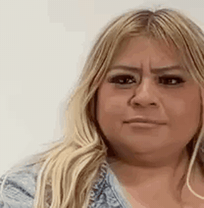 A Close Up Of A Woman 'S Face With A Serious Expression . GIF