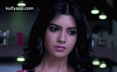 A Close Up Of A Woman 'S Face With A Serious Expression . GIF