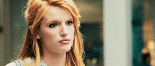 A Close Up Of A Woman 'S Face With A Serious Expression GIF
