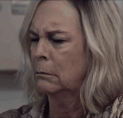 A Close Up Of A Woman 'S Face With A Serious Expression GIF