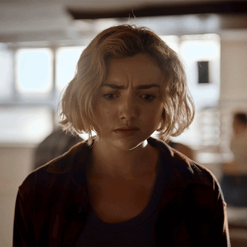 A Close Up Of A Woman 'S Face With A Serious Expression GIF