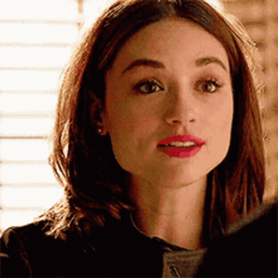 A Close Up Of A Woman 'S Face With A Serious Expression . GIF
