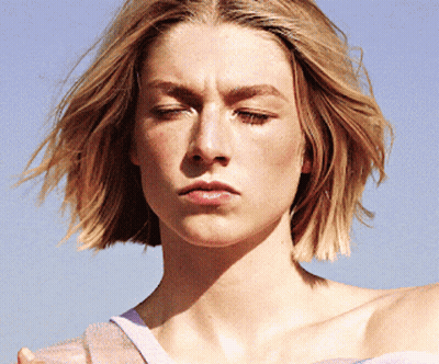 A Close Up Of A Woman 'S Face With A Serious Look On Her Face GIF