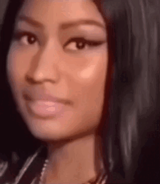 A Close Up Of A Woman 'S Face With A Serious Look On Her Face And A Necklace . GIF