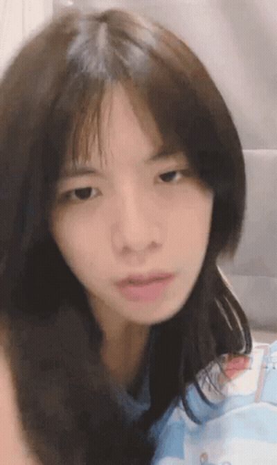A Close Up Of A Woman 'S Face With A Serious Look On Her Face GIF