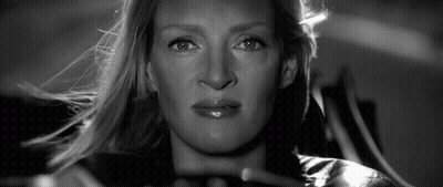 A Close Up Of A Woman 'S Face With A Serious Look On Her Face GIF