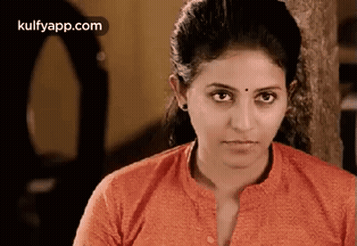 A Close Up Of A Woman 'S Face With A Serious Look On Her Face . GIF