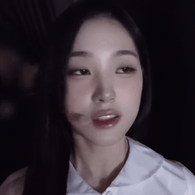 A Close Up Of A Woman 'S Face With A Shadow On Her Face GIF