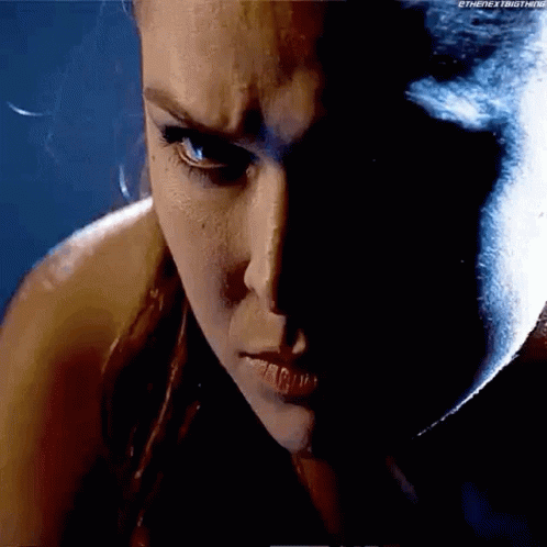 A Close Up Of A Woman 'S Face With A Shadow On It . GIF