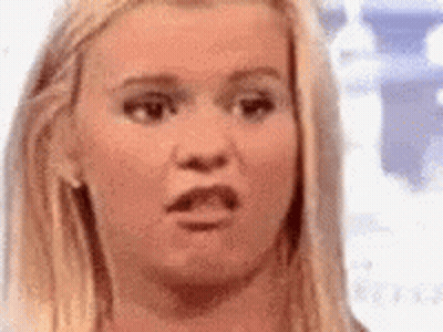 A Close Up Of A Woman 'S Face With A Shocked Look On Her Face . GIF