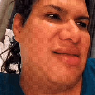 A Close Up Of A Woman 'S Face With A Slight Smile On Her Face GIF