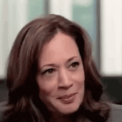 A Close Up Of A Woman 'S Face With A Slight Smile On Her Face . GIF