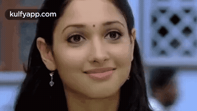 A Close Up Of A Woman 'S Face With A Smile . GIF