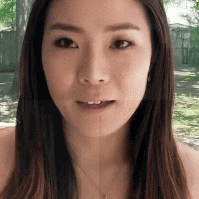 A Close Up Of A Woman 'S Face With A Smile On Her Face GIF