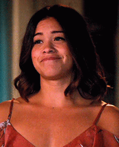 A Close Up Of A Woman 'S Face With A Smile On Her Face . GIF