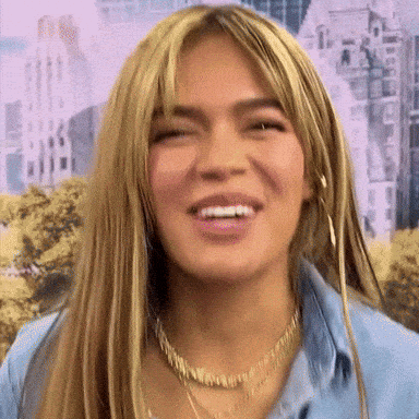 A Close Up Of A Woman 'S Face With A Smile On Her Face . GIF