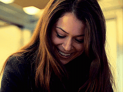 A Close Up Of A Woman 'S Face With A Smile On Her Face . GIF