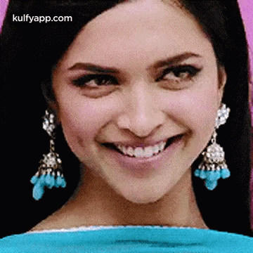 A Close Up Of A Woman 'S Face With A Smile On Her Face . GIF